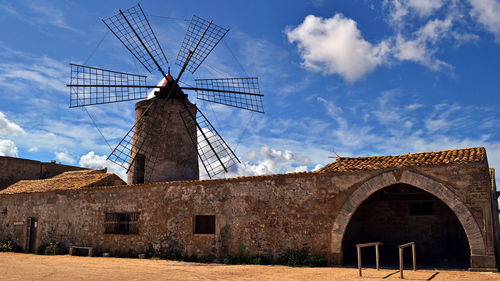 Traditional windmill against sky