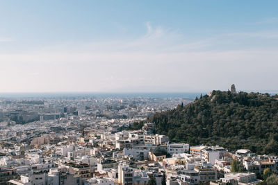 Cityscape by sea against sky