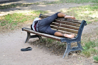 Woman sitting on bench in park