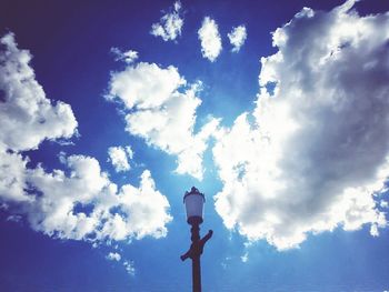 Low angle view of street light against cloudy sky