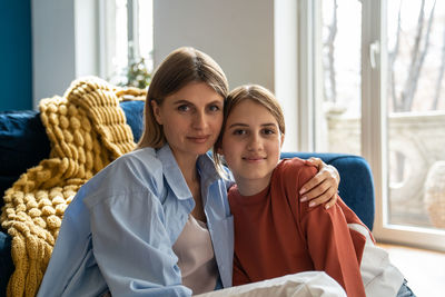 Portrait of mother and daughter at home