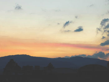 Scenic view of silhouette mountains against sky at sunset