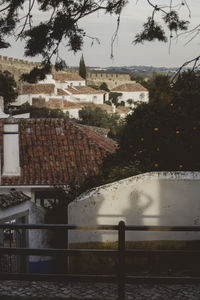 High angle view of buildings and trees against sky