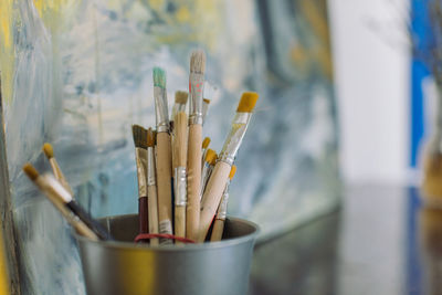 Close-up of paintbrushes in container
