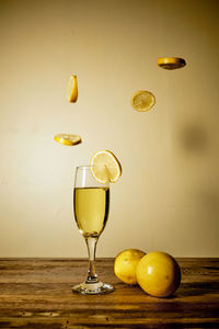 Close-up of drink in glass with lime on table