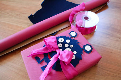 High angle view of wrapped gift box by equipment on table