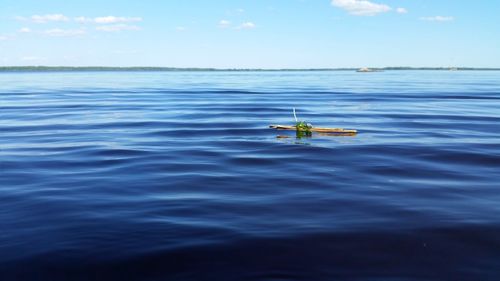 Man in sea against sky