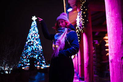 Woman wearing knit hat standing outdoors