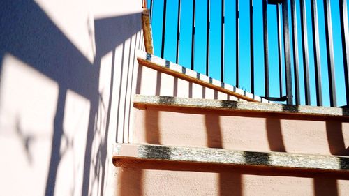 Shadow of railing on building wall