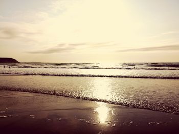 Scenic view of beach against sky during sunset