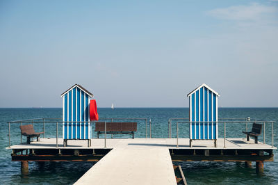 Lifeguard hut on beach against sky