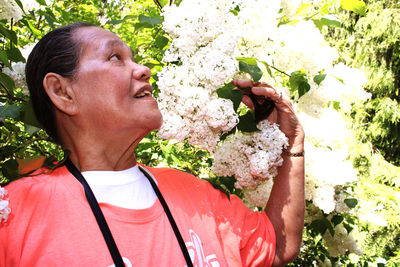 Portrait of woman holding plant