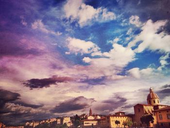 Buildings against cloudy sky