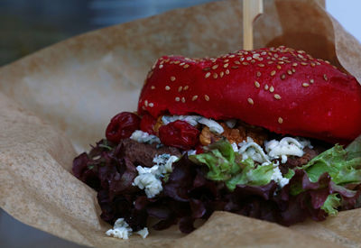 Close-up of burger on wax paper