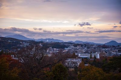 Cityscape against sky at sunset