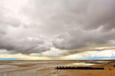 Scenic view of sea against cloudy sky