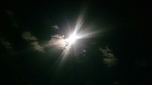 Low angle view of sun in sky