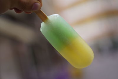 Close-up of hand holding ice cream