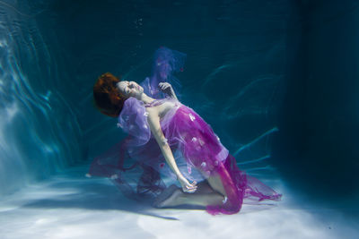 High angle view of woman swimming in sea