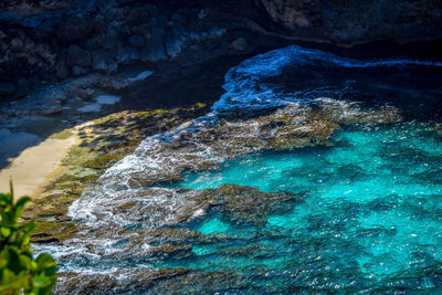 High angle view of rock formation in sea