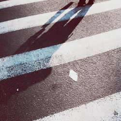Shadow of person on zebra crossing