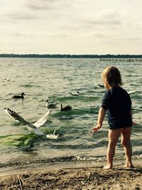 Full length of girl standing on shore