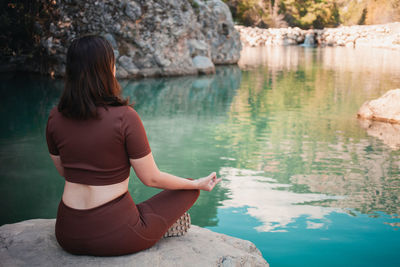 Rear view of woman looking at lake