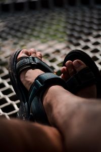 Low section of man wearing sandals