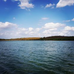 Scenic view of calm sea against cloudy sky