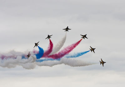 Military airplanes with vapor trails in sky