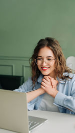 Young woman using laptop at home