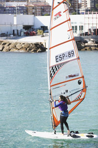 Full length of woman on boat in sea