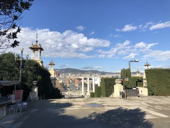 Buildings in city against cloudy sky