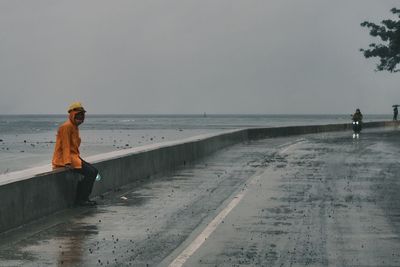 Man on beach against clear sky
