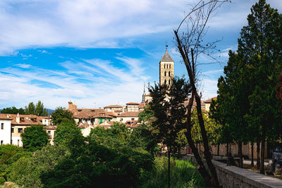 Panoramic view of trees and buildings against sky