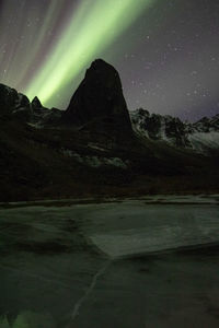 Scenic view of mountains against sky at night