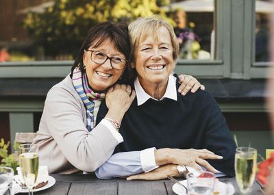 Portrait of smiling man and woman at table