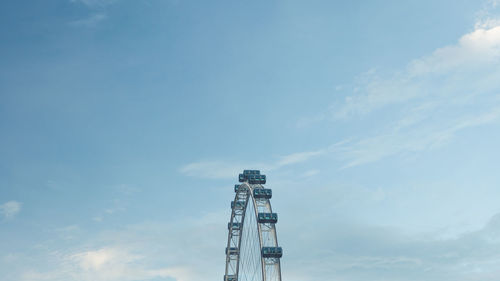 Low angle view of communications tower against sky