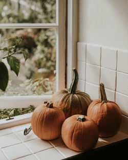 Close-up of pumpkins on window sill at home