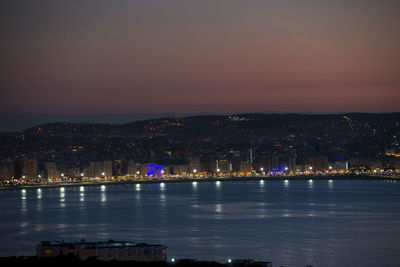 Illuminated city at waterfront