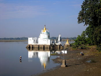 View of building by sea against sky