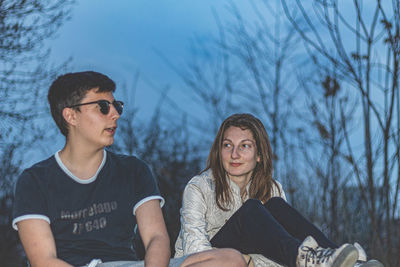 Portrait of a young couple sitting outdoors