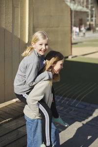 Girl giving friend piggyback ride