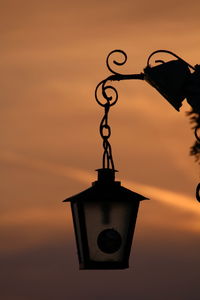 Close-up of silhouette metal against sky during sunset