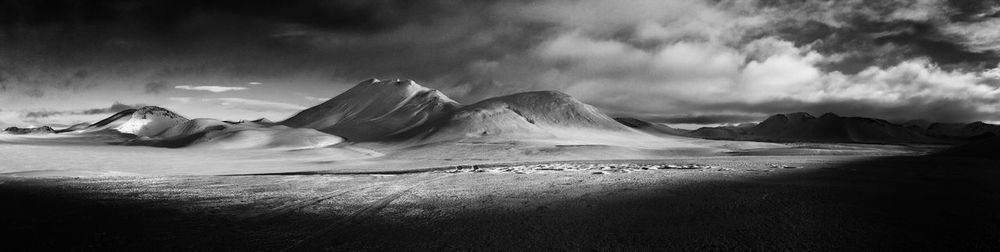 Scenic view of mountains against cloudy sky