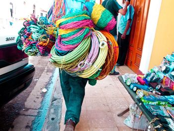 Man holding multi colored balloons