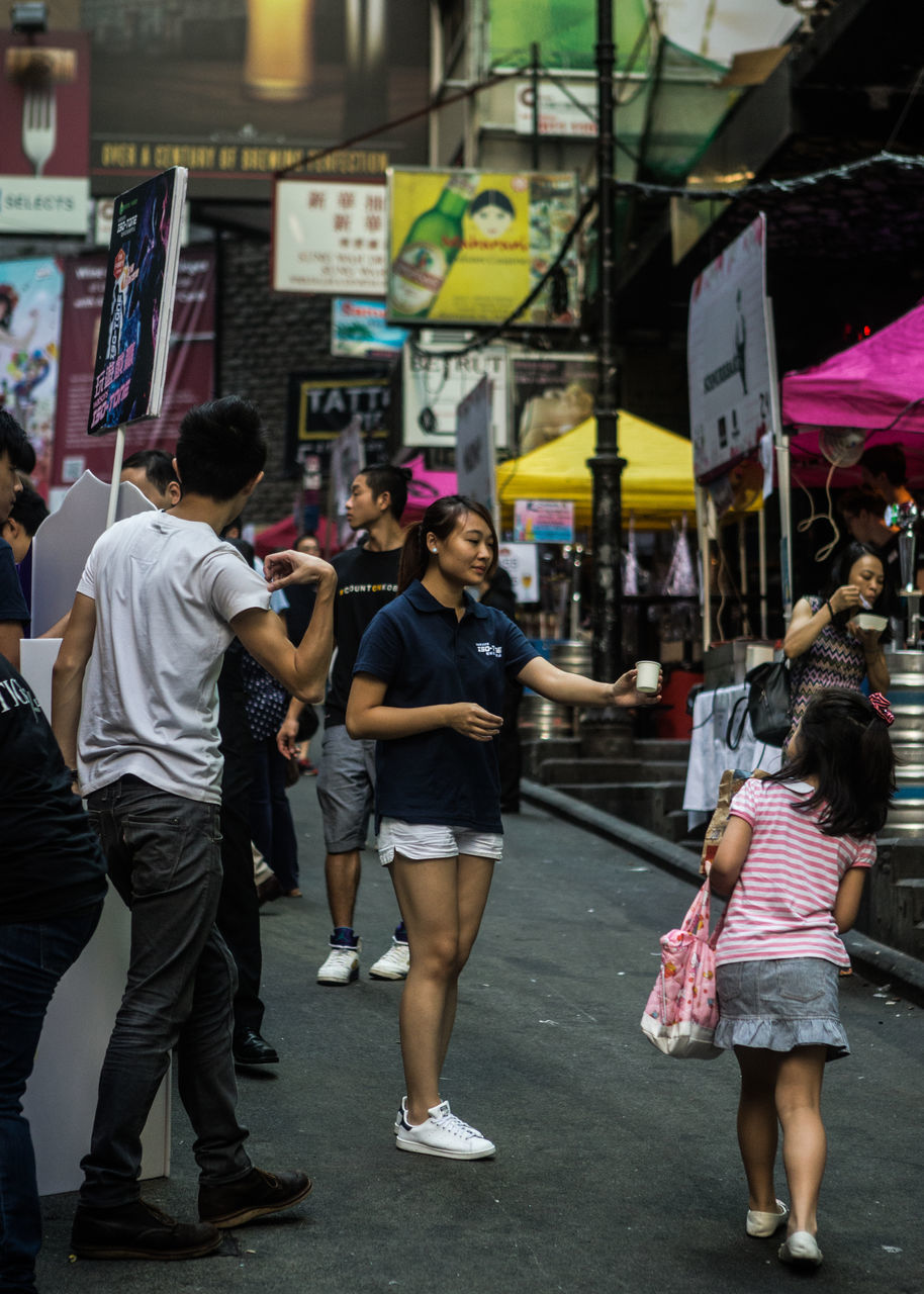 real people, walking, casual clothing, street, rear view, men, lifestyles, leisure activity, women, full length, outdoors, standing, day, togetherness, city, building exterior, architecture