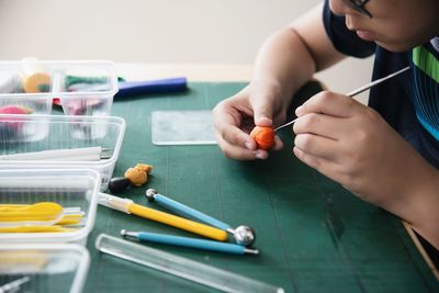 Midsection of boy studying at desk