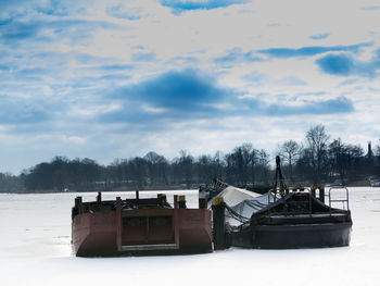 Scenic view of snow covered landscape against cloudy sky