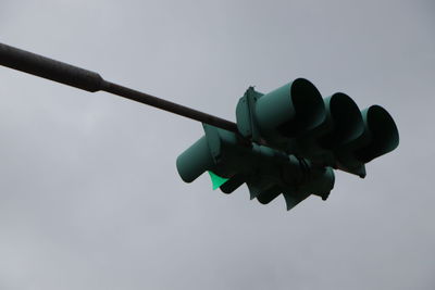 Low angle view of illuminated lighting equipment against sky